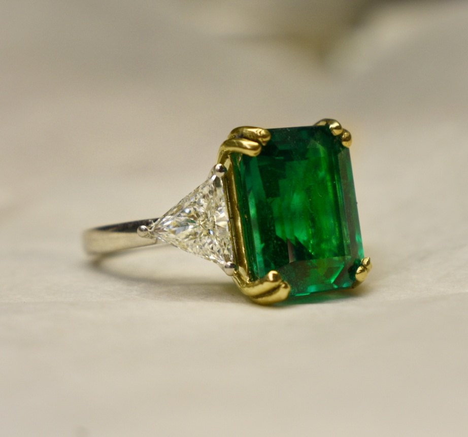 A custom Anderson emerald-cut emerald and trillion-diamond three-stone ring